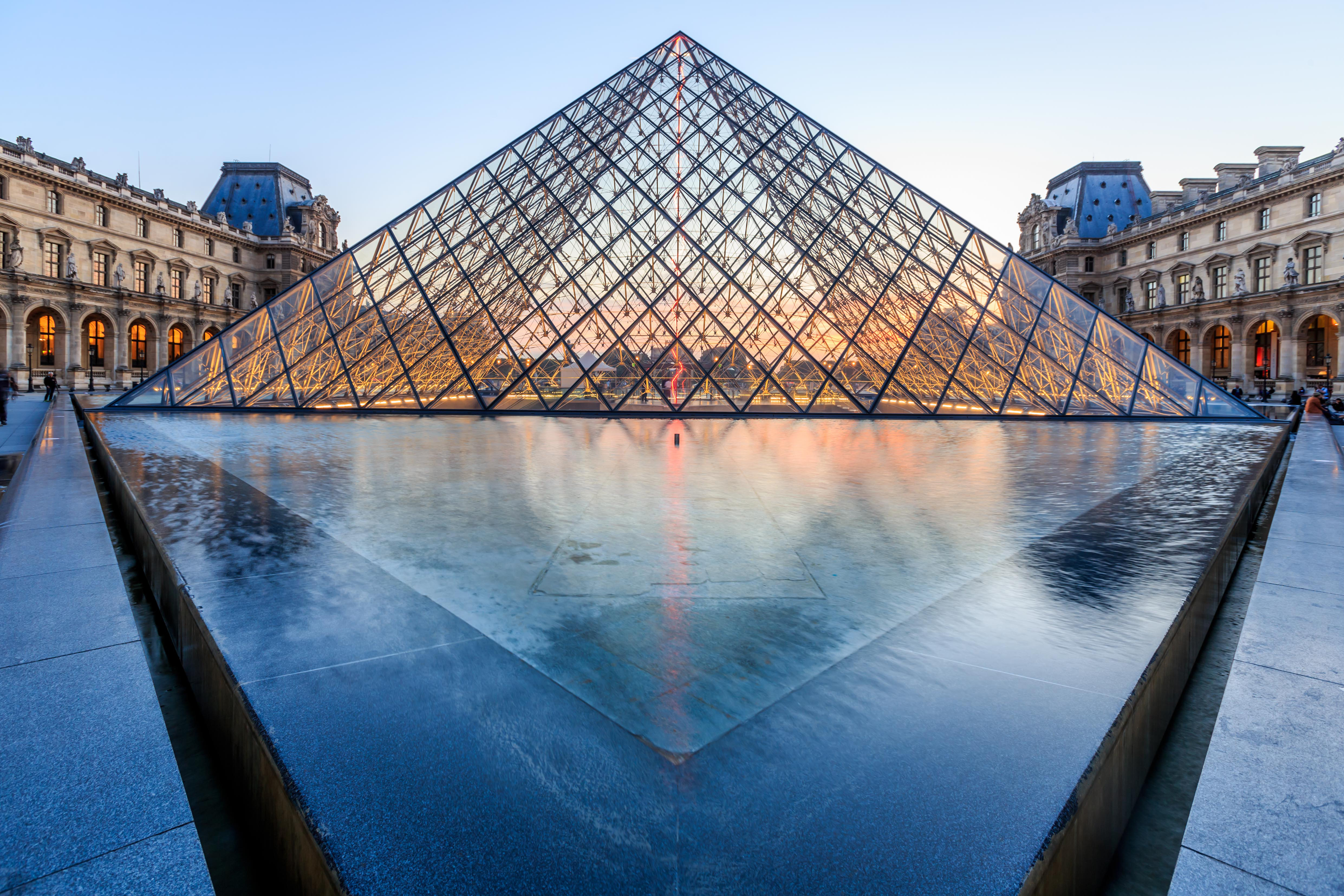 The Louvre Pyramid at dusk. 